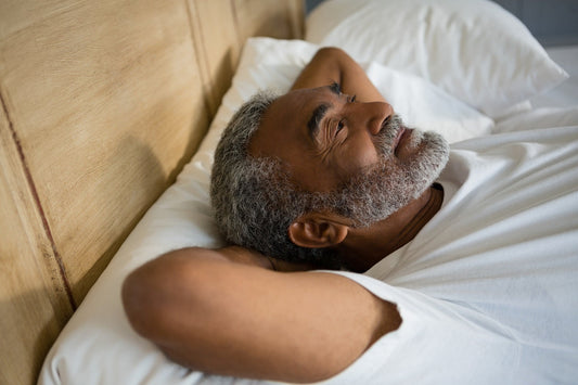 Older Adult relaxing peacefully on bed from CBN