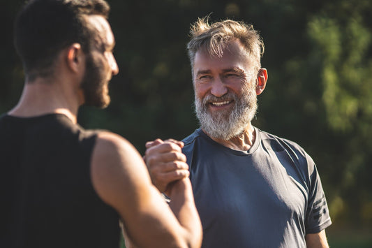 happy senior father and son handshaking and celebrating fathers day