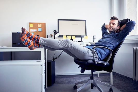 Senior man taking nap at work for restorative recharge