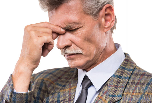 Senior man experiencing headache behind the eyes