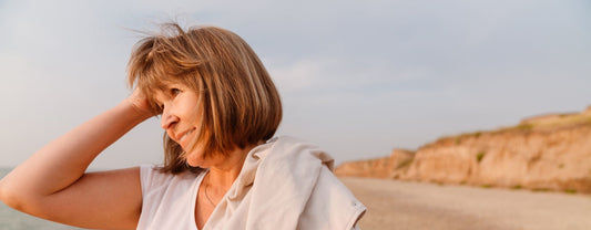Senior woman with menopause enjoying beach
