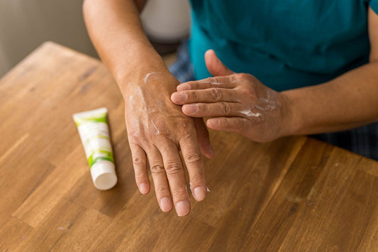 cbd lotion being rubbed into senior hands