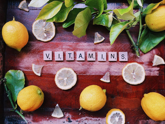 Vitamins written on scrabble pieces surrounded by lemons