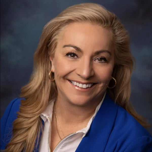 Jamie Pearson Cannabis industry executive and 55plus CBD advisory board member wearing a blue blazer against a dark background